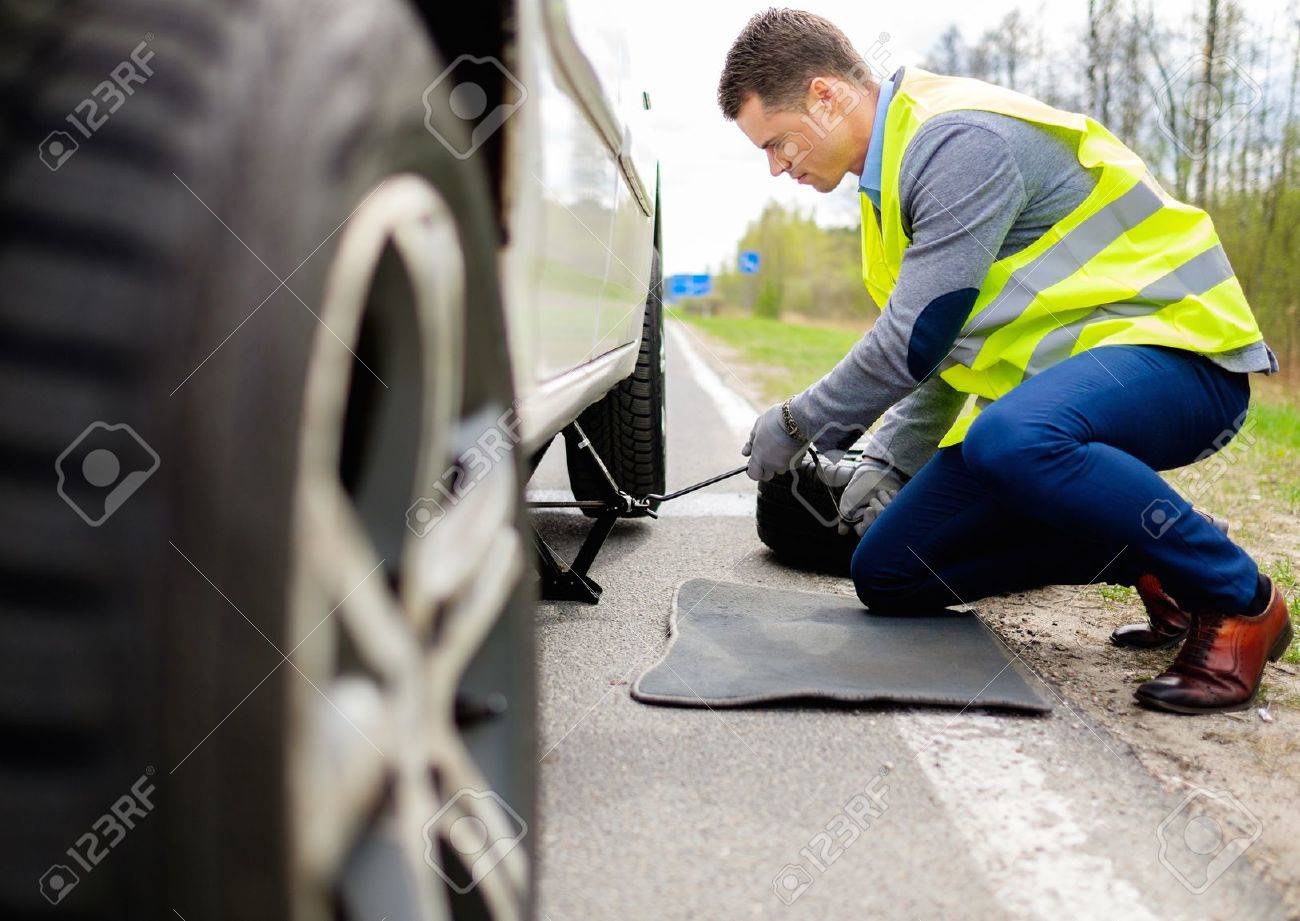 39546108 man changing wheel on a roadside Stock Photo